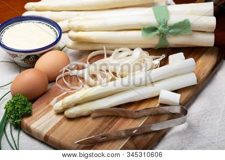 Bunch Of Fresh Uncooked White Asparagus And Peeler Knife, How To Peel Asparagus Vegetables, Close Up