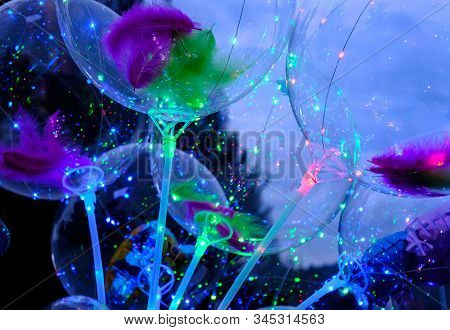 Defocused Image Of Neon Lights Of Illuminated Balloons Filled With Hellium With Led Light At Night