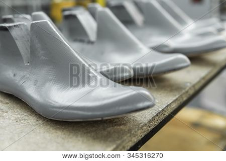 Plastic Lasts Used In The Manufacture Of Shoes. Row Of Plastic Shoe Lasts Used To Manufacture Modern