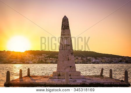 Beautiful Panoramic View Of The City At Sunset And An Obelisk Monument In Greek Town Argostoli On Ke