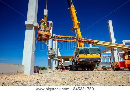 Zrenjanin, Vojvodina, Serbia - April 20, 2018: Mobile Crane Is Operating And Worker Is Assembly Conc