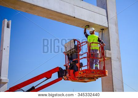 Zrenjanin, Vojvodina, Serbia - April 20, 2018: Mobile Crane Is Operating And Worker Is Assembly Conc