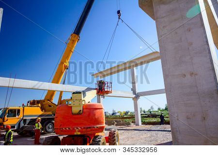 Zrenjanin, Vojvodina, Serbia - April 20, 2018: Mobile Crane Is Operating And Worker Is Assembly Conc