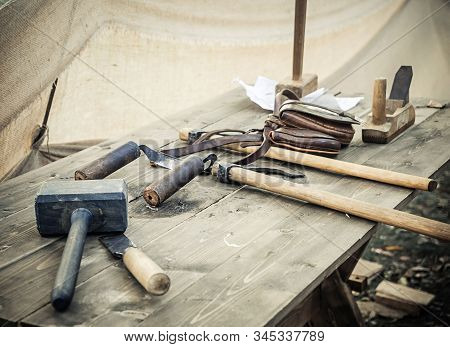 Old Woodworking Hand Tool: Wooden Plane, Chisel Ax, Sledgehammer, Hammer And In A Carpentry Workshop