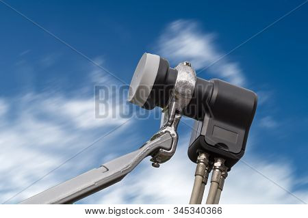 The Lnb Of A Satellite Dish Against The Blue Sky. Used For Digital Sat Tv.