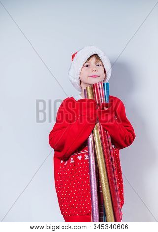 Charming Boy Wearing Santa's Hat In Red Sweater
