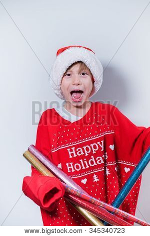 Charming Boy Wearing Santa's Hat In Red Sweater