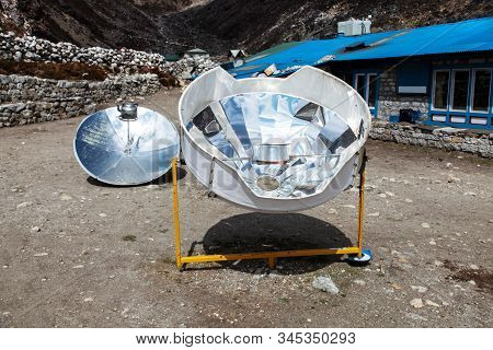 Warming The Teapot In A Solar Cooker. Ecology Concept. Renewable Green Energy. Nepal. Himalaya.
