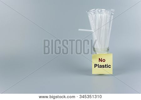 White Plastic Straw On Gray Background With Copy Space For Text. Environmental Protection, Zero Wast