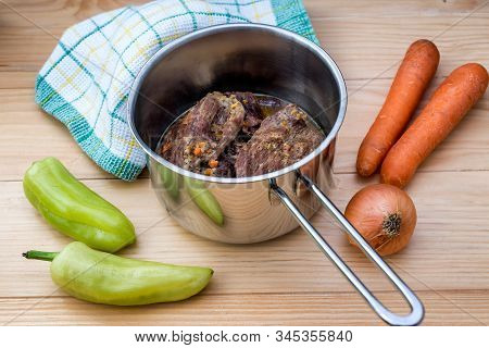 Traditionally Made Beef Steaks In Sauce With Carrots And Onions Offered As Closeup In A Cast Iron Sa