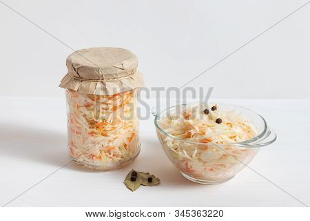 Homemade Sauerkraut. Fermented Food. Sauerkraut With Carrots In Glass Jar And Bowl With Fork On Wood