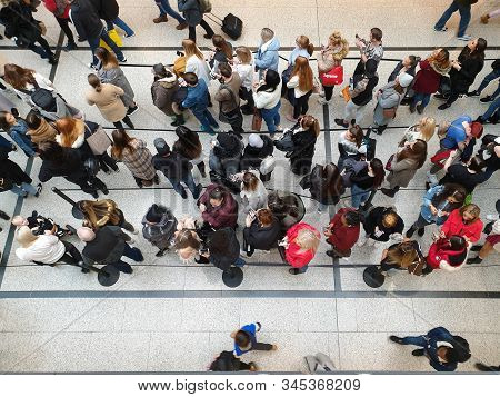 Manchester, United Kingdom - November 23, 2019: Top View Of People Gazing At Their Mobile Phones Whi