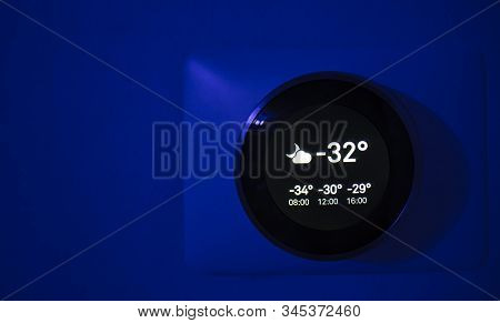 Digital Thermostat At Night Showing The Outside Temperature Of -31 Degrees Celsius During The Winter