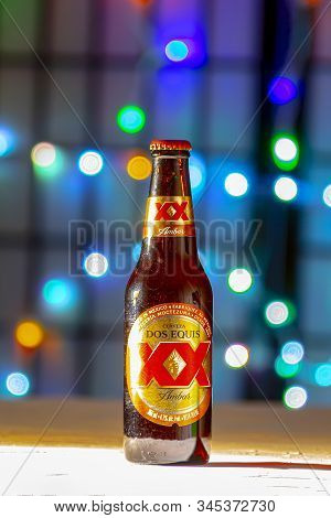 Calgary Alberta Canada. Jan 23 2020. A Brown Bottle Of Dos Equis Beer. A Mexican Beer On A White Tex