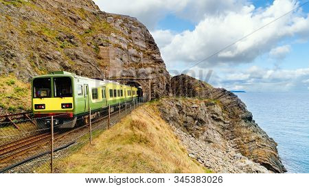 Closeup Of Train Exiting A Tunnel. View From Cliff Walk Bray To Greystones With Beautiful Coastline,