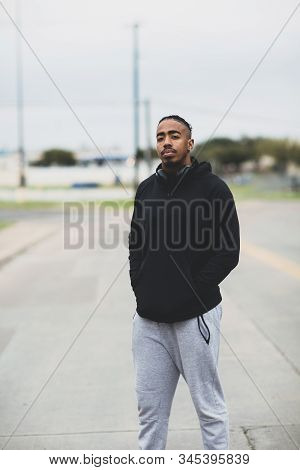 Young African American Man Outside Wearing A Hoddie.