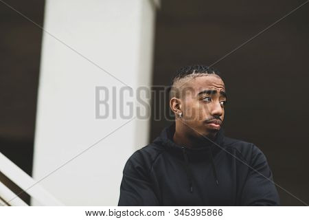 Young African American Man Outside Wearing A Hoddie.