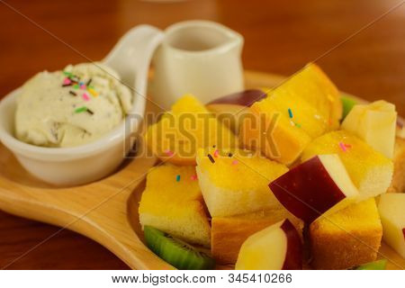 Close Up And Deatail Of Honey Toast On A Wooden Plate