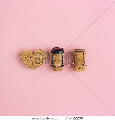 Toys Girl And Boy Characters From Champagne Corks And Muselets On Pink Colored Background. Love And 