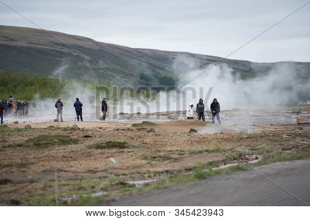 Tourists Visiting Strokkur Geyser In Iceland