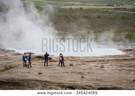 Tourists Visiting Strokkur Geyser In Iceland
