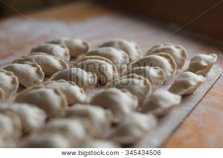 Vareniki, Dumplings With Potatoes On White Background - Traditional Ukrainian Food. Cooking Raw Dump