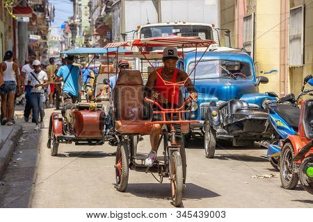 Havana, Cuba - May 16, 2019: Bicycle Taxi Driver In The Street Of Old Havana City During A Vibrant A