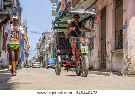 Havana, Cuba - May 16, 2019: Bicycle Taxi Driver In The Street Of Old Havana City During A Vibrant A