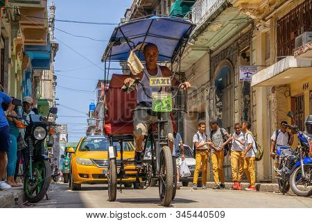 Havana, Cuba - May 16, 2019: Bicycle Taxi Driver In The Street Of Old Havana City During A Vibrant A