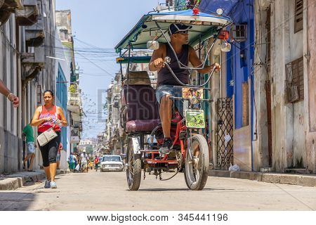 Havana, Cuba - May 16, 2019: Bicycle Taxi Driver In The Street Of Old Havana City During A Vibrant A