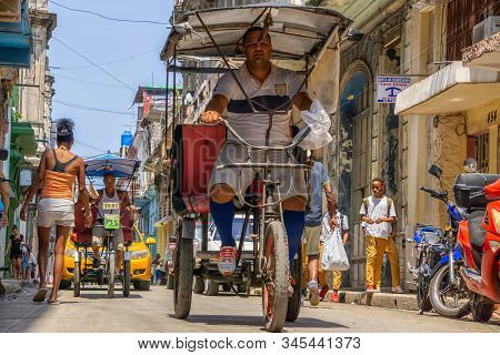 Havana, Cuba - May 16, 2019: Bicycle Taxi Driver In The Street Of Old Havana City During A Vibrant A