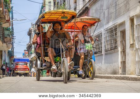 Havana, Cuba - May 16, 2019: Bicycle Taxi Driver In The Street Of Old Havana City During A Vibrant A
