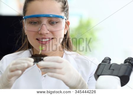 A Woman In Close-up, A Scientist Biologist In A Research Laboratory Examines The Biotechnical Proper