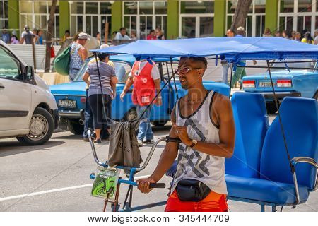 Havana, Cuba - May 16, 2019: Bicycle Taxi Driver In The Street Of Old Havana City During A Vibrant A