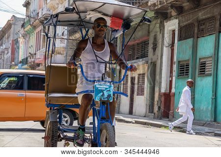 Havana, Cuba - May 16, 2019: Bicycle Taxi Driver In The Street Of Old Havana City During A Vibrant A