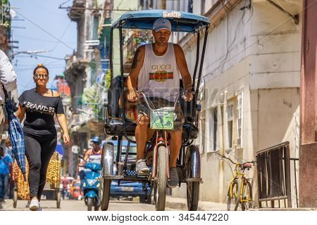 Havana, Cuba - May 16, 2019: Bicycle Taxi Driver In The Street Of Old Havana City During A Vibrant A