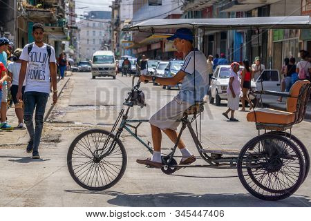 Havana, Cuba - May 16, 2019: Bicycle Taxi Driver In The Street Of Old Havana City During A Vibrant A