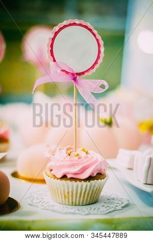 Raspberry Cupcake With A Sign For Inscription With A Bow