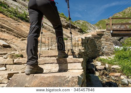 Low Angle View Of Hikin Boots Ascending Steps.
