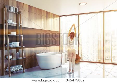 Woman In Panoramic Gray Bathroom With Tub
