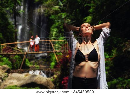 Woman near Labuhan Kebo Waterfall located in Munduk, Bali