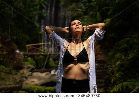 Woman near Labuhan Kebo Waterfall located in Munduk, Bali