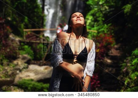 Woman near Labuhan Kebo Waterfall located in Munduk, Bali