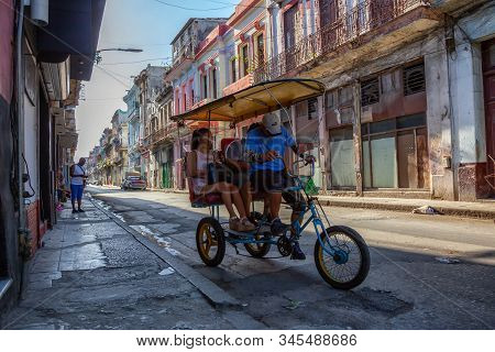 Havana, Cuba - May 13, 2019: Bicycle Taxi Driver Riding In The Streets Of Old Havana City During A V
