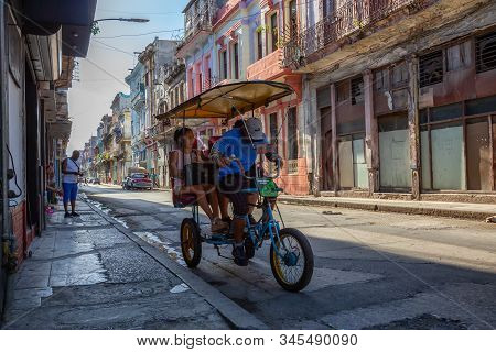 Havana, Cuba - May 13, 2019: Bicycle Taxi Driver Riding In The Streets Of Old Havana City During A V