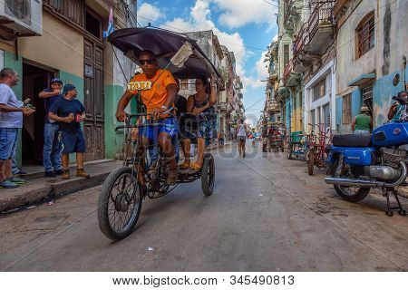 Havana, Cuba - May 13, 2019: Bicycle Taxi Driver Riding In The Streets Of Old Havana City During A V
