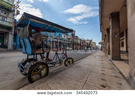 Havana, Cuba - May 14, 2019: Bicycle Taxi Driver Riding In The Streets Of Old Havana City During A V