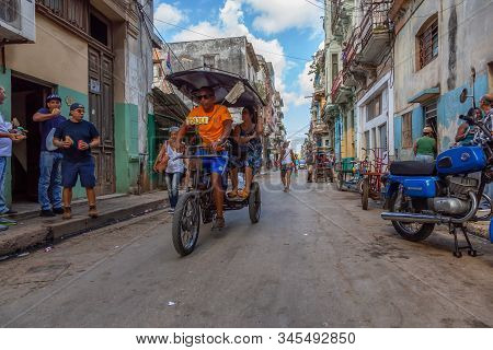 Havana, Cuba - May 13, 2019: Bicycle Taxi Driver Riding In The Streets Of Old Havana City During A V