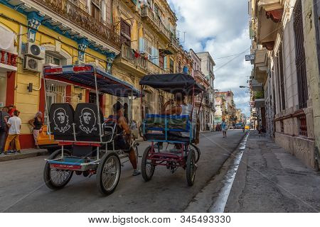Havana, Cuba - May 13, 2019: Bicycle Taxi Driver Riding In The Streets Of Old Havana City During A V
