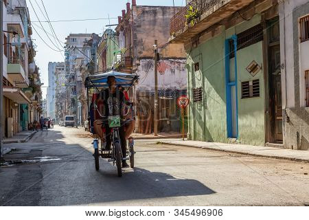 Havana, Cuba - May 13, 2019: Bicycle Taxi Driver Riding In The Streets Of Old Havana City During A V